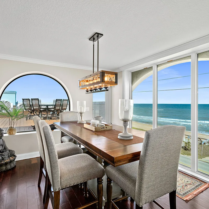 Dining room with arched window and Atlantic Ocean views in the oceanfront penthouse