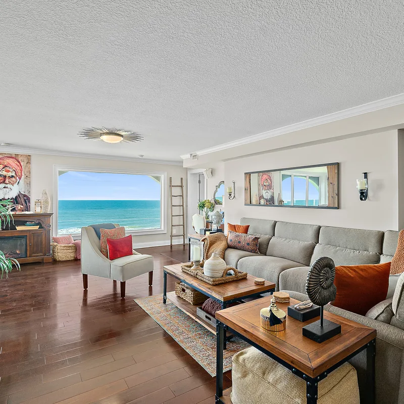 Living room with floor-to-ceiling Atlantic Ocean views in the Ormond Beach oceanfront penthouse